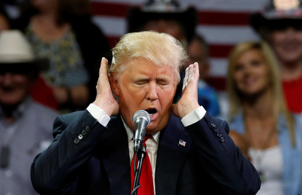 Republican presidential candidate Donald Trump jokes about how difficult he says it is for him to listen to Democratic candidate Hillary Clinton's voice as he holds a rally with supporters in Fresno, California, May 27, 2016.