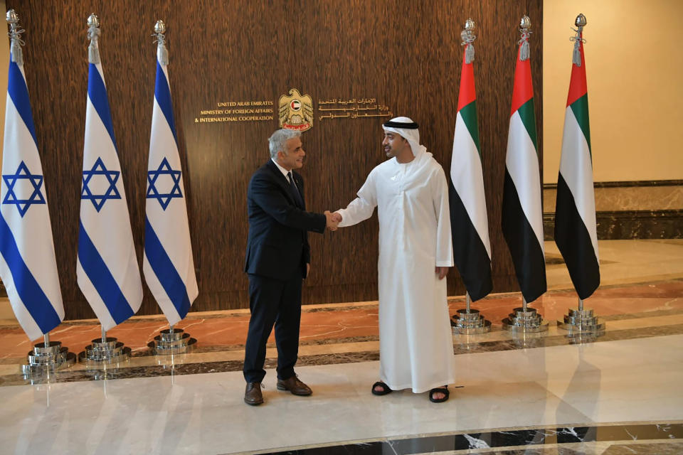 In this photo made available by the Israeli Government Press Office, Israeli Foreign Minister Yair Lapid shakes hands with United Arab Emirates Foreign Minister Sheikh Abdullah bin Zayed al-Nahyan in Abu Dhabi, United Arab Emirates, Tuesday, June 29, 2021. Lapid kicked off the highest-level visit by an Israeli official to the UAE on Tuesday, nine months after the two established relations in a deal brokered by the United States. (Shlomi Amsalem/Government Press Office via AP)