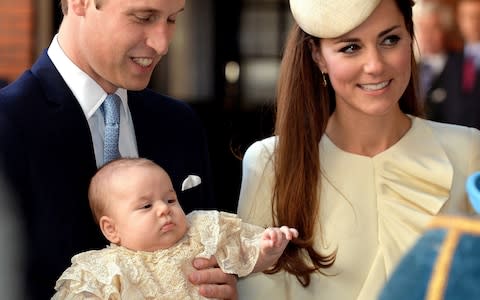 Prince William and The Duchess of Cambridge with Prince George of Cambridge on the day of his christening - Credit: JOHN STILLWELL /AFP