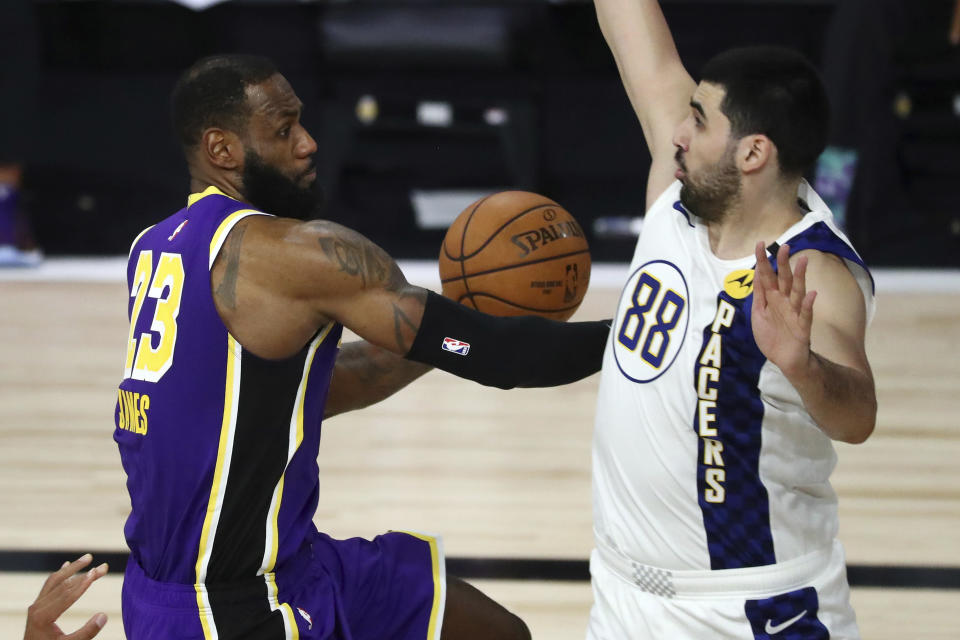 Los Angeles Lakers forward LeBron James (23) drives to the basket against Indiana Pacers center Goga Bitadze (88) during the second quarter of an NBA basketball game Saturday, Aug. 8, 2020, in Lake Buena Vista, Fla. (Kim Klement/Pool Photo via AP)