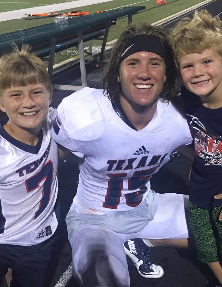 Cody Stoever, left, used to attend Wimberley games when older brother Cade, center, played for the Texans. Their younger brother, Colt, right, is in the sixth grade.