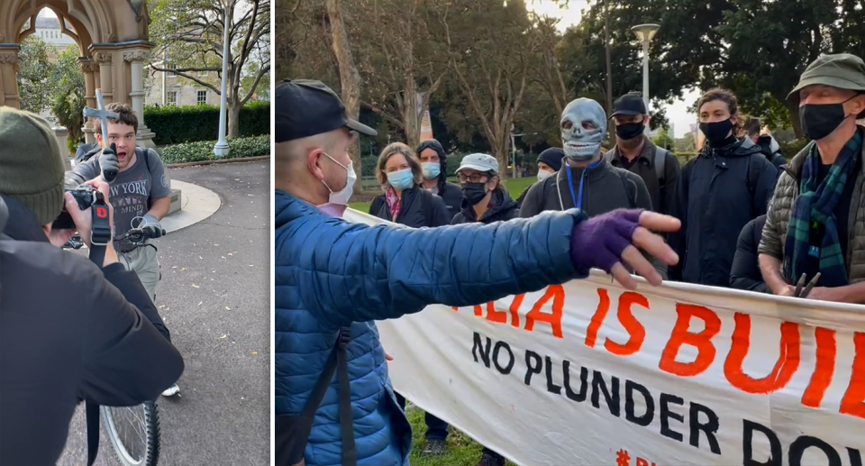 A lone counter-protester thrust a crucifix towards the climate protesters. Source: Michael Dahlstrom / Yahoo News Australia