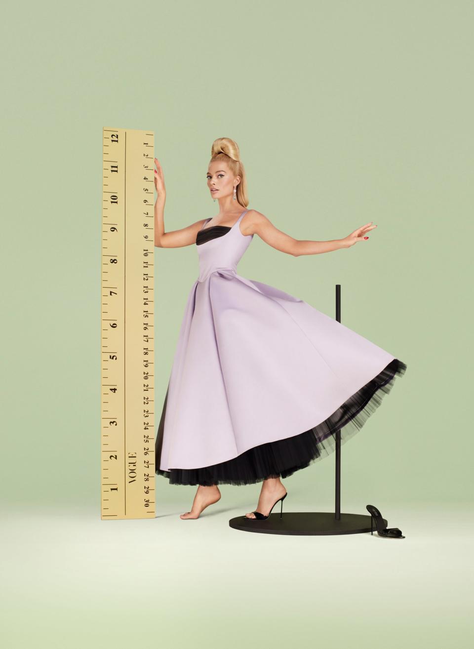 MADE TO MEASURE
The film&#x002019;s look is &#x00201c;a mad fantasy of gorgeousness,&#x00201d; says Barbie set designer Sarah Greenwood. Robbie wears a Carolina Herrera dress. Paris Texas shoes. Chopard earrings.