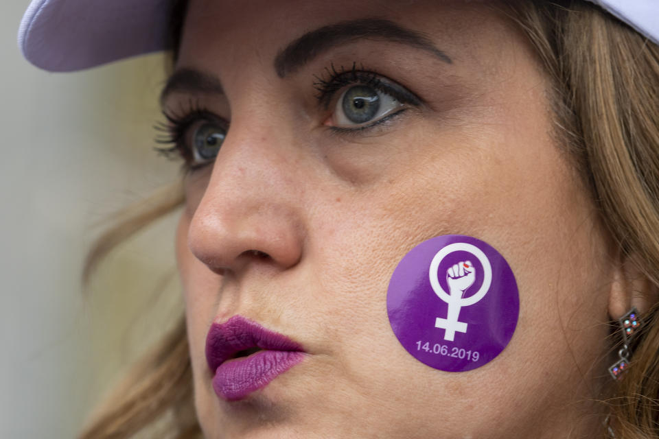 A woman protests in front of the University Hospitals during a nationwide women's strike in Geneva, Switzerland, June 14, 2019. The strike day intends to highlight, among others, unequal wages, pressures on part-time employees, the burden of household work and sexual violence. (Martial Trezzini/Keystone via AP)