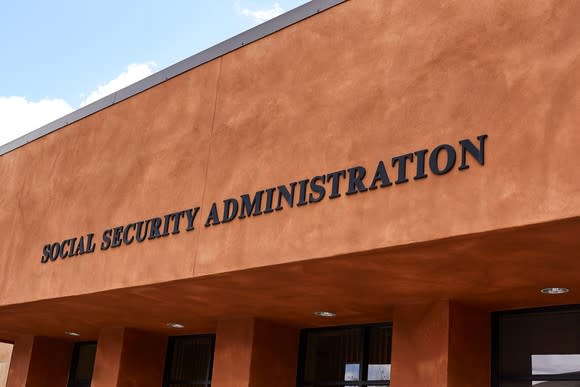 Brown stucco building with Social Security Administration on the side above glass doors.