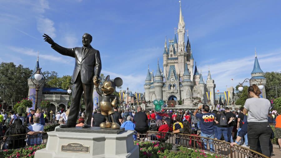 <sub>Guests watch a show near a statue of Walt Disney and Micky Mouse in front of the Cinderella Castle at the Magic Kingdom at Walt Disney World in Lake Buena Vista, Fla., on Jan. 9, 2019. The Walt Disney Company reported their corporate results on Feb. 8, 2023. (AP File Photo/John Raoux)</sub>