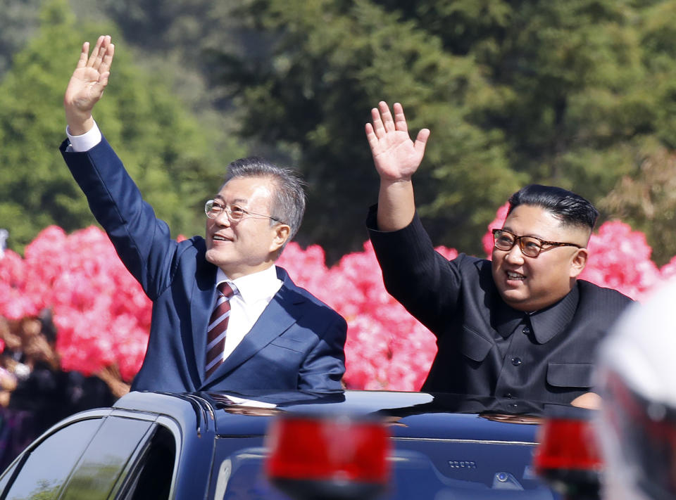 <p>South Korean President Moon Jae-in, left, and North Korean leader Kim Jong Un wave from a car during a parade through a street in Pyongyang, North Korea. (Pyongyang Press Corps Pool via AP, File) </p>