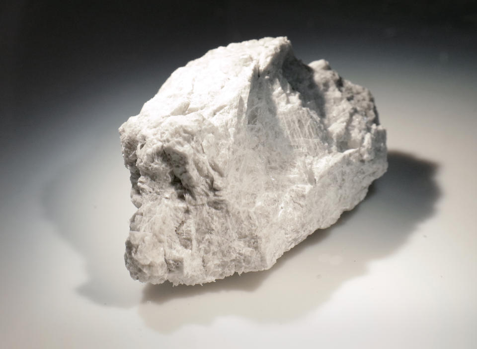 The "Genesis Rock," a 4.4 billion-year-old anorthosite sample approximately 2 inches in length, brought back by Apollo 15 and used to determine the moon was formed by a giant impact, is lit inside a pressurized nitrogen-filled examination case in the lunar lab at the NASA Johnson Space Center Monday, June 17, 2019, in Houston. (AP Photo/Michael Wyke)