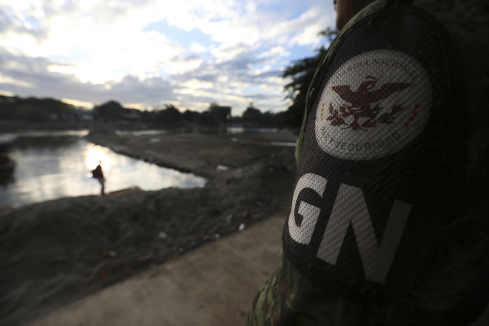 A Mexican National Guard patrols near the bridge that crosses the Suchiate River, on the border with Guatemala, near Ciudad Hidalgo, Mexico, Friday, Jan. 17, 2020. United States officials are crediting tough measures taken over the past year and cooperation from regional governments for sharply reducing the number of Central American migrants who responded to a call for a new caravan. (AP Photo/Marco Ugarte)