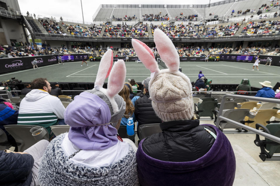 JoAnne Brekjern, at left, and her daughter Tessa Jochim wear Easter Bunny ears on Easter during the championship match between Ons Jabeur, of Tunisia, and Belinda Bencic, of Switzerland, at the Charleston Open tennis tournament in Charleston, S.C., Sunday, April 9, 2023. (AP Photo/Mic Smith)