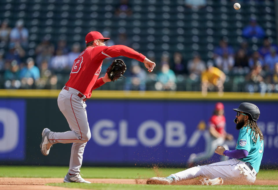 Los Angeles Angels second baseman Brandon Drury tags out Seattle Mariners' J.P. Crawford but cannot complete the double play on Julio Rodriguez at first during the first inning of a baseball game, Wednesday, Sept. 13, 2023, in Seattle. (AP Photo/Lindsey Wasson)