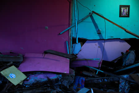 A photograph hangs on a wall of a house hit by tsunami in Palu, Central Sulawesi, Indonesia, October 13, 2018. REUTERS/Jorge Silva