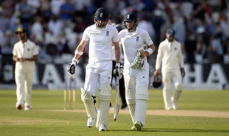 England's James Anderson and Joe Root leave the field not out at the finish of the third day's play during the first cricket test match against India at Trent Bridge cricket ground in Nottingham, England July 11, 2014. REUTERS/Philip Brown