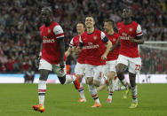 Arsenal's players celebrate their win against Wigan Athletic at the end of their English FA Cup semifinal soccer match at Wembley Stadium in London, Saturday, April 12, 2014. (AP Photo/Sang Tan)