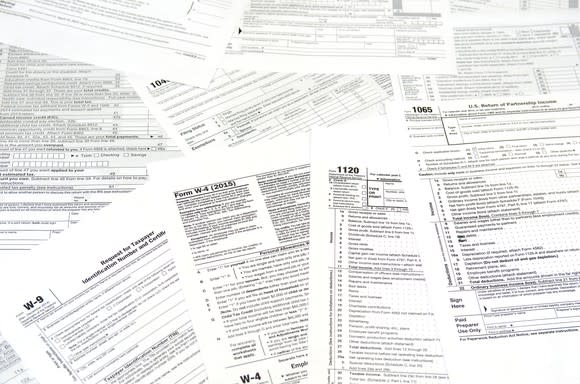 Various IRS tax forms and instructions laid out across a flat surface.