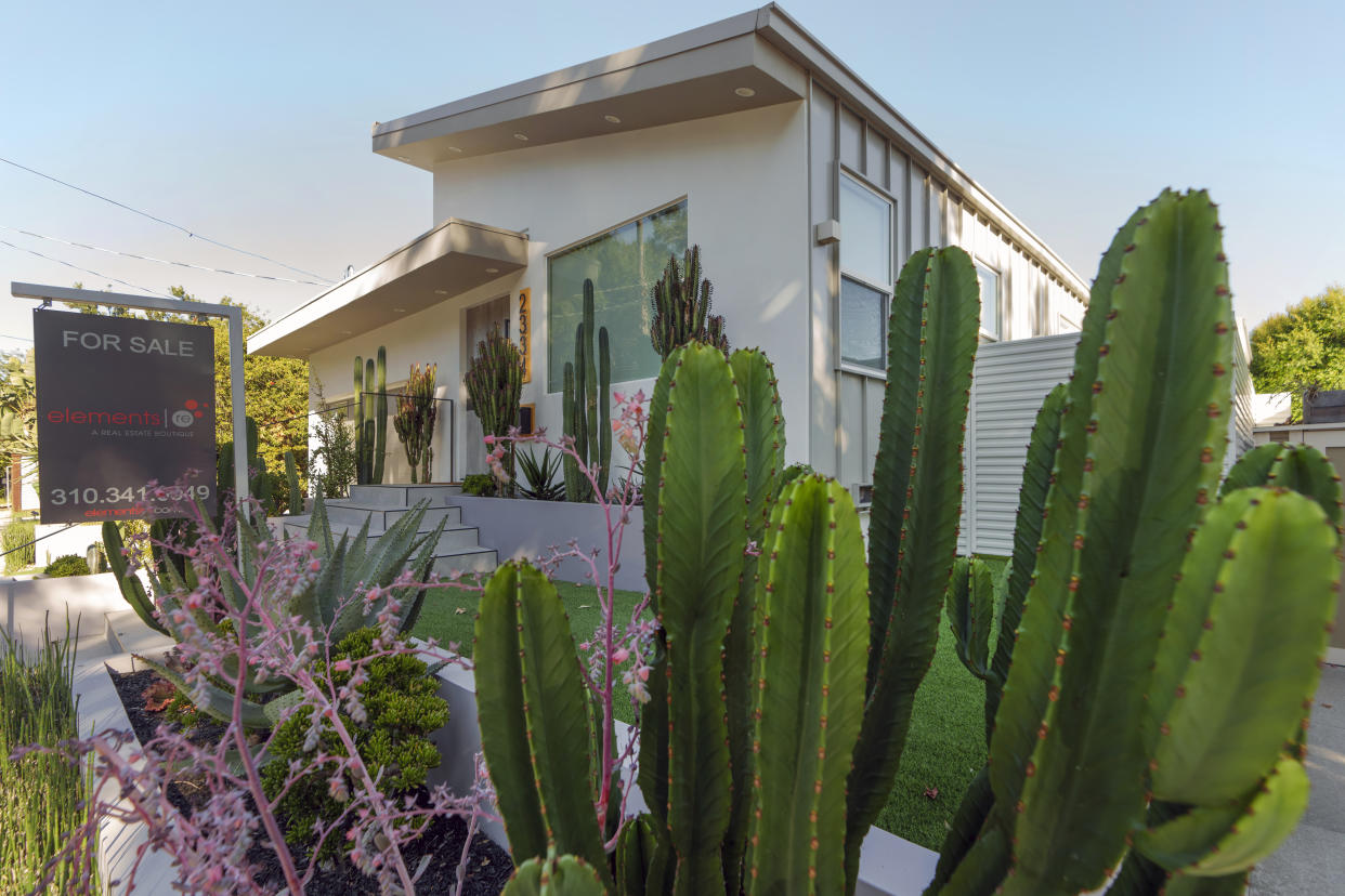 Desert landscape decorates a home for sale in Los Angeles, on Thursday, Oct. 19, 2023. Sales of previously occupied U.S. homes in September fell for the fourth month in a row, grinding to their slowest pace in more than a decade as prospective homebuyers grapple with surging mortgage rates and a near historic-low level of properties on the market. (AP Photo/Damian Dovarganes)