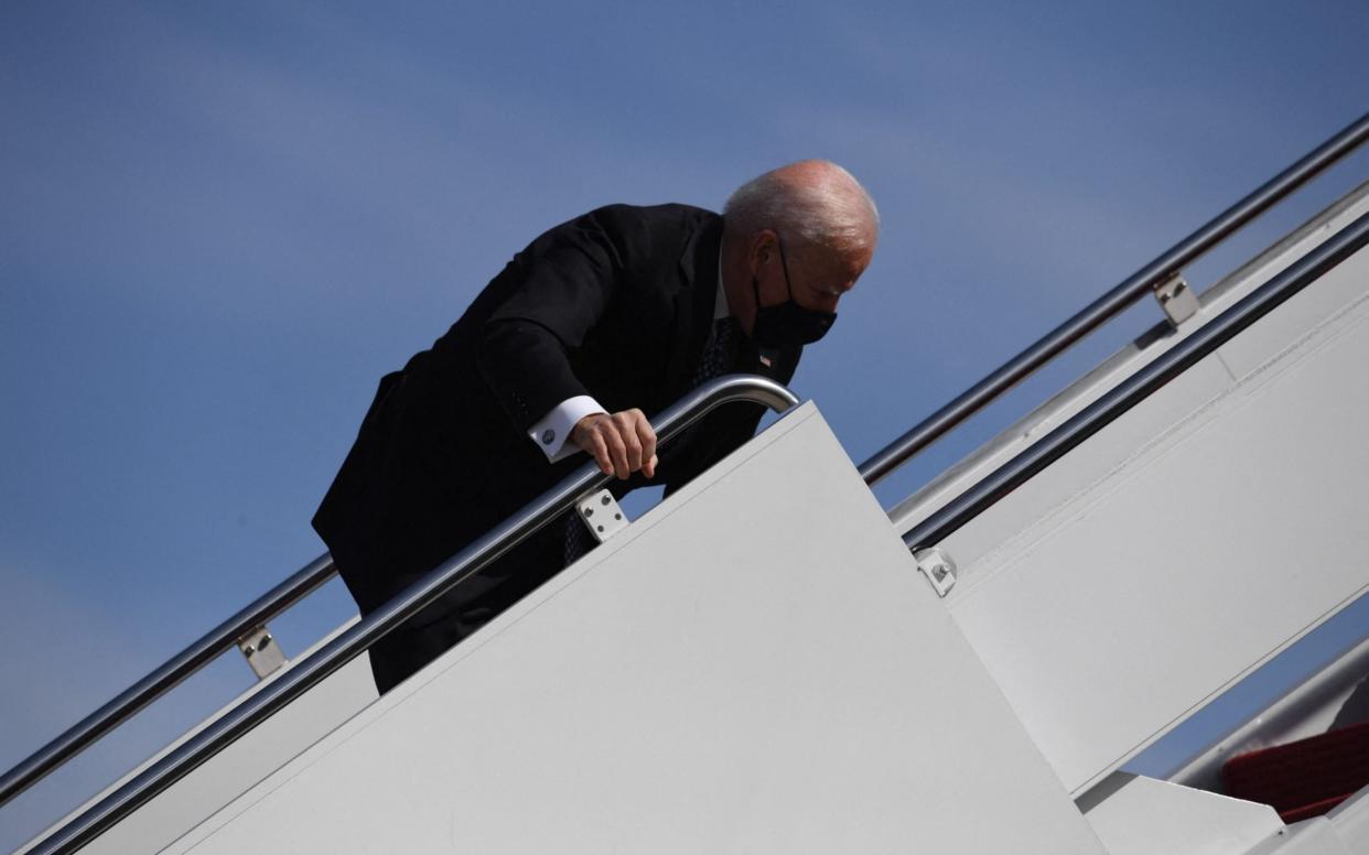 US President Joe Biden trips as he boards Air Force One at Joint Base Andrews in Maryland - AFP