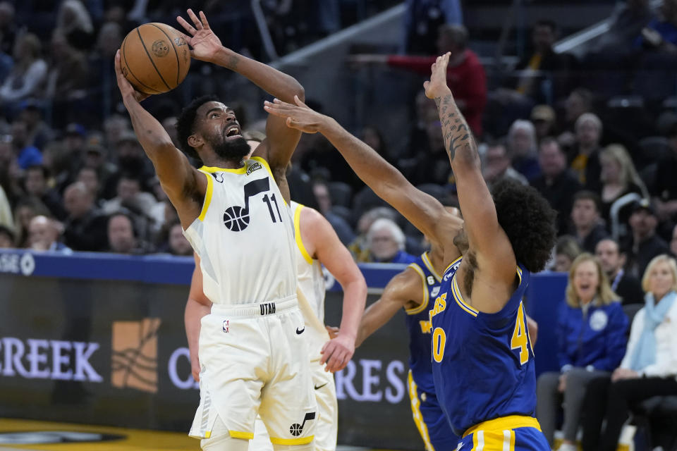 Utah Jazz guard Mike Conley (11) shoots against Golden State Warriors forward Anthony Lamb during the second half of an NBA basketball game in San Francisco, Wednesday, Dec. 28, 2022. (AP Photo/Jeff Chiu)