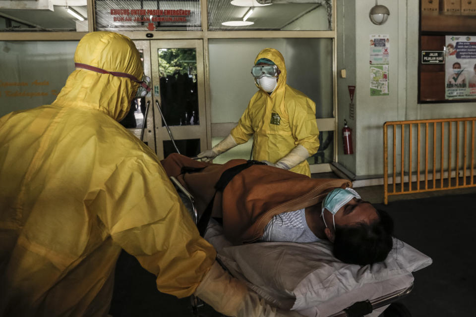 Health workers wearing protective moves a patient to isolation ward during exercise in handling suspected coronavirus patient in Sanglah General Hospital, Denpasar, Bali, Indonesia.