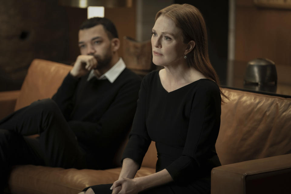 This image released by Apple TV+ shows Justice Smith, left, and Julianne Moore in a scene from "Sharper." (Apple TV+ via AP)