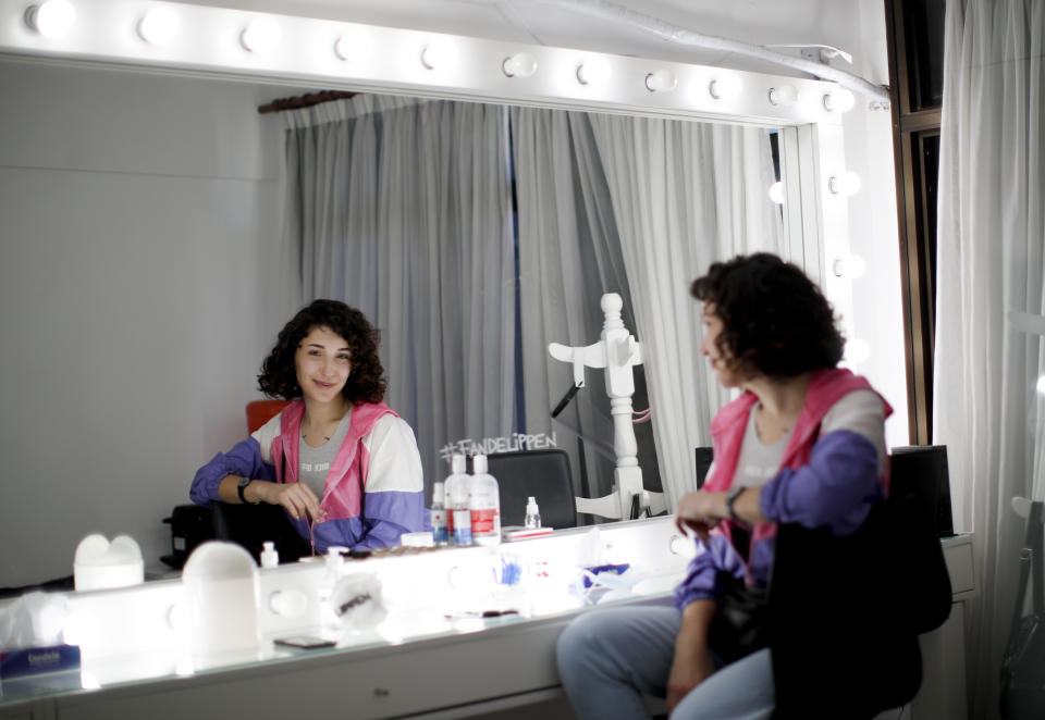 Artist Emma Lusicich poses for a photo in the mirror where she works at a beauty salon that specializes in sculpting eyebrows in Buenos Aires, Argentina, Friday, Nov. 20, 2020. Lusicich said the most important thing for transgender rights is the education of society. (AP Photo/Natacha Pisarenko)