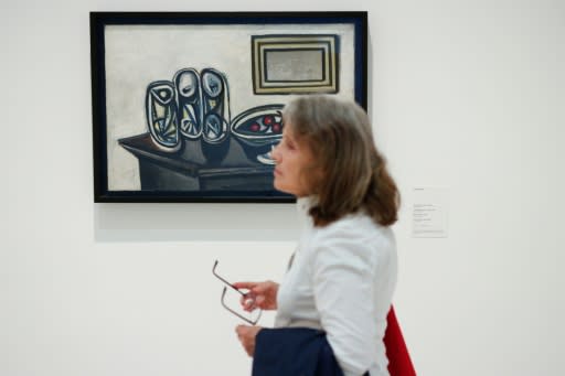 A woman walks past "Still Life with Cherries" -- another manifestation of the intimate connection between food and the extraordinary art of Pablo Picasso