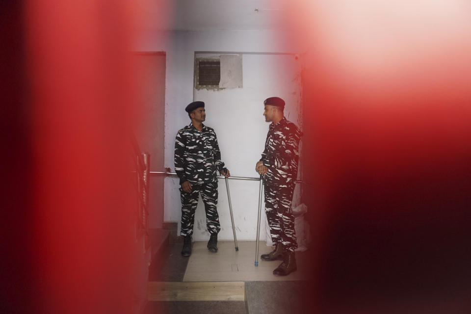 Security officers stand guard outside the office of NewsClick in New Delhi, India, Tuesday, Oct. 3, 2023. Indian police raided the offices of the news website that's under investigation for allegedly receiving funds from China, as well as the homes of several of its journalists, in what critics described as an attack on one of India's few remaining independent news outlets. (AP Photo/Dinesh Joshi)