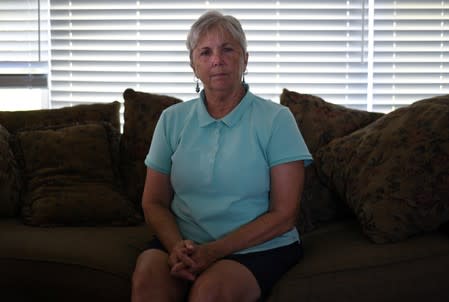 Janet Putrah, a retired university IT supervisor, poses for a photo in her home in Mankato