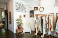 The store’s entry contains a selection of clean white ensembles.