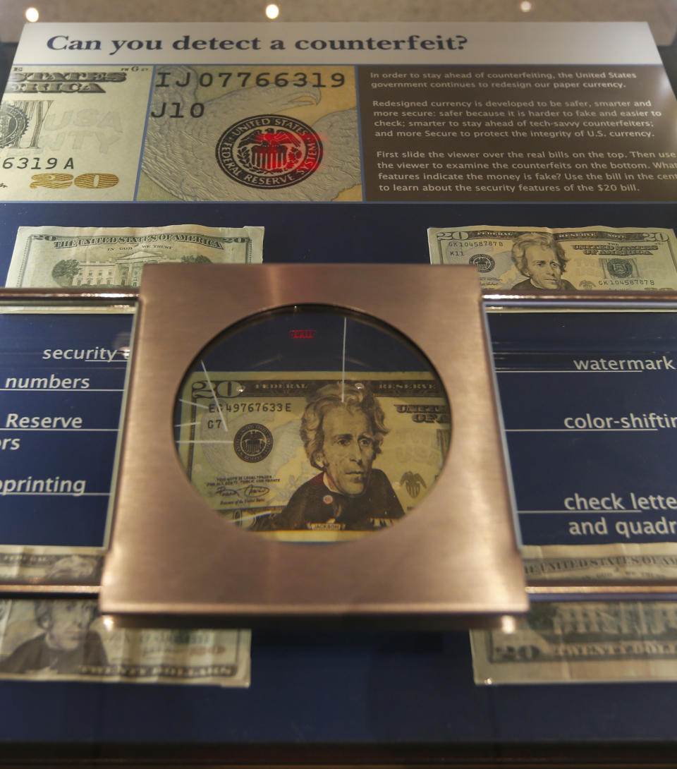 This Feb. 11, 2014 photo shows a display about detecting counterfeit money is a display at The Money Museum in Kansas City, Mo. The Money Museum at the Federal Reserve Bank of Kansas City is a one-stop shop for many things dollar. The museum takes visitors through the history of modern currency and the Fed system. (AP Photo/Orlin Wagner)