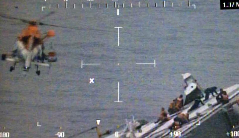 Still image shows a South Korean maritime police helicopter rescuing passengers from a sinking ship in the sea off Jindo