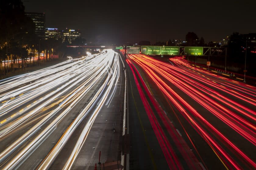 COSTA MESA, CALIF. -- WEDNESDAY, DECEMBER 11, 2019: A long exposure of cars traveling on 405 freeway at dusk in Costa Mesa, Calif., on Dec. 11, 2019. (Allen J. Schaben / Los Angeles Times)