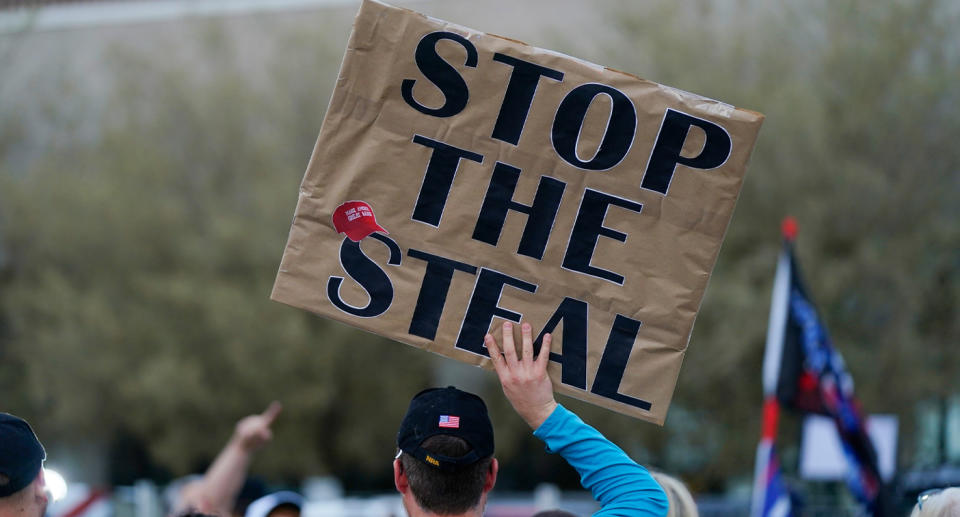 A Trump support holds Stop the Steal sign in protest of votes being counted.