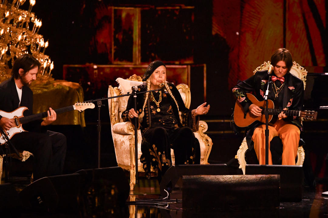 Canadian-US singer-songwriter Joni Mitchell (C) and US singer-songwriter Brandi Carlile (R) perform on stage during the 66th Annual Grammy Awards at the Crypto.com Arena in Los Angeles on February 4, 2024. (Photo by Valerie Macon / AFP) (Photo by VALERIE MACON/AFP via Getty Images)