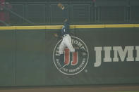 Seattle Mariners center fielder Kyle Lewis makes a leaping catch of a deep fly ball hit by Oakland Athletics' Ramon Laureano with two outs and the bases loaded during the first inning of the second baseball game of a doubleheader, Monday, Sept. 14, 2020, in Seattle. The air at the ballpark was thick with smoke from wildfires. (AP Photo/Ted S. Warren)