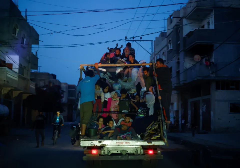 Palestinians ride on a vehicle as they flee Rafah on May 9, 2024.