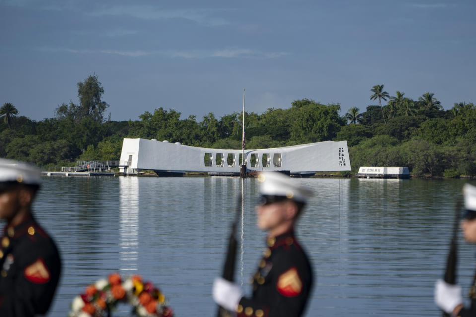 U.S. Marines fire a salute in front of the USS Arizona Memorial during the 82nd Pearl Harbor Remembrance Day ceremony on Thursday, Dec. 7, 2023, at Pearl Harbor in Honolulu, Hawaii. (AP Photo/Mengshin Lin)
