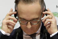 German Foreign Minister Heiko Maas adjusts the headphones during a press conference with his Cyprus' counterpart Nicos Christodoulides at the foreign ministry house in divided Nicosia, Cyprus, Tuesday, Oct. 13, 2020. Maas is in Cyprus for a one-day visit. (AP Photo/Petros Karadjias)