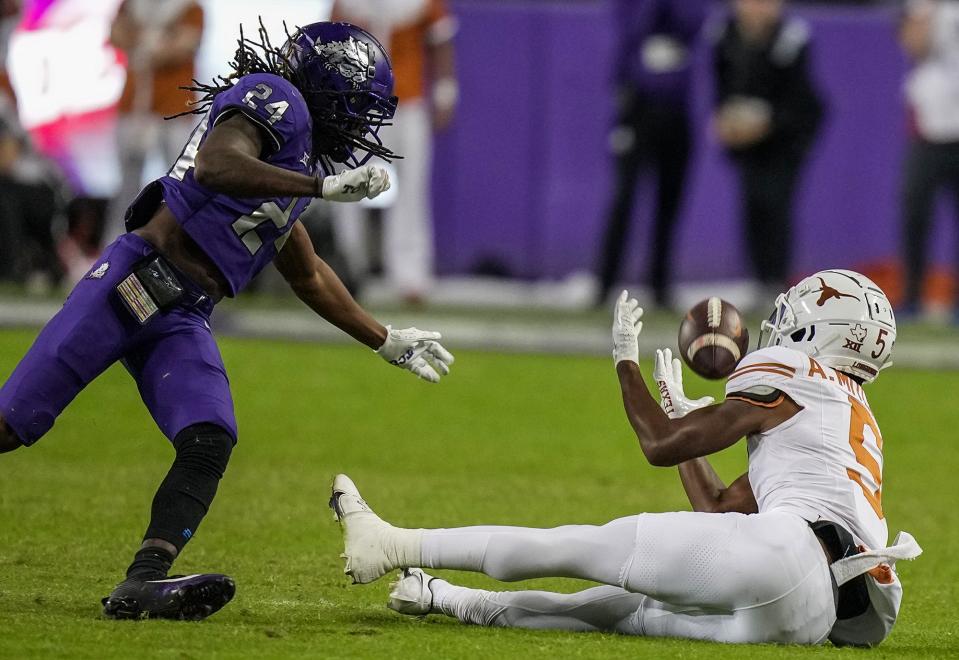 Texas receiver Adonai Mitchell hauls in a 35-yard catch late in Saturday's win over TCU in Fort Worth. The athletic, twisting catch on third-and-12 in the final 2 minutes of the game sealed the 29-26 win.