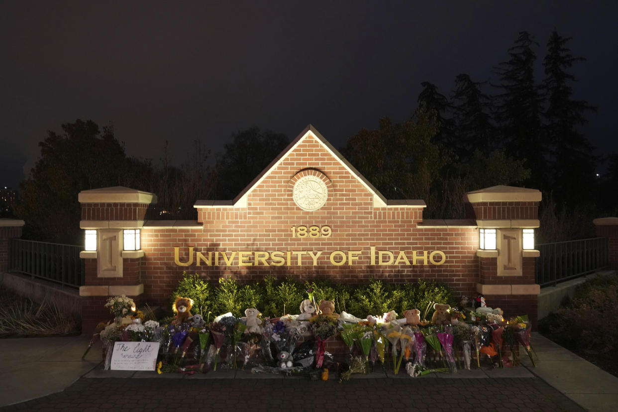 Flowers and other items are displayed at a growing memorial in front of a campus entrance sign for the University of Idaho, Wednesday, Nov. 16, 2022, in Moscow, Idaho. Four University of Idaho students were found dead on Sunday, Nov. 13, 2022, at a residence near campus. (AP Photo/Ted S. Warren)