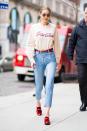 <p>In high-rise denim cinched with a bright red belt, a nude-colored crewneck sweatshirt, red loafers, and circular sunglasses while out in New York.</p>
