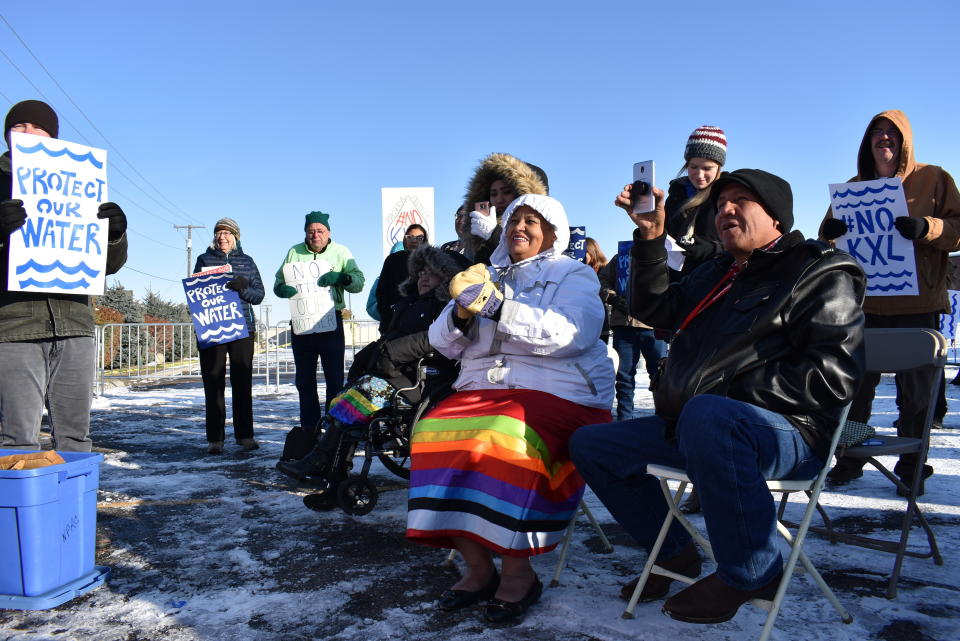 Opponents of the Keystone XL oil pipeline from Canada are seen demonstrating in sub-freezing temperatures on Tuesday, Oct. 29, 2019 in Billings, Mont. The State Department has released a new environmental study of the long-stalled, $8 billion project. (AP Photo/Matthew Brown)
