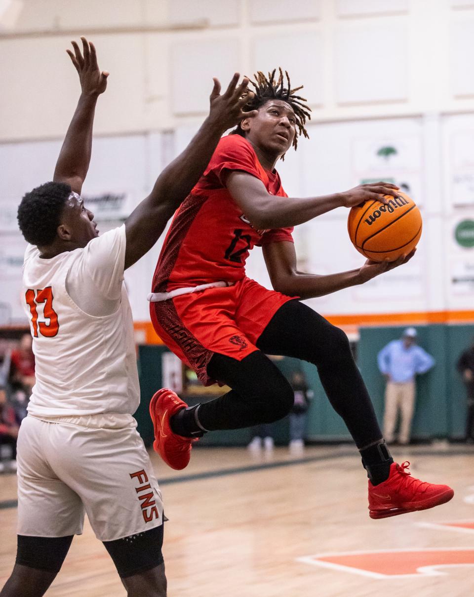 Bay freshman Tramello Carter glides by Mosley junior Randy Pittman for a shot. Mosley hosted Bay in a boys basketball game Friday, January 14, 2022. Bay left with the win, 58-46.
