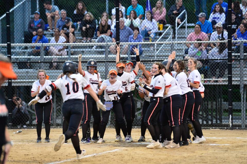 Taunton’s Kaysie Demoura is greeted by teammates after hitting a home run during the Division 1 Final Four game against Methuen held at Worcester State.