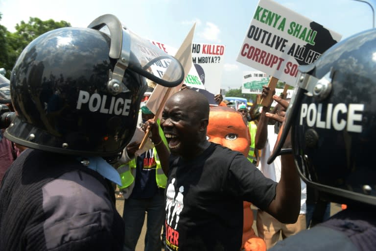 A man shouts at police during a demonstration to highlight corruption in government, in Nairobi on February 13, 2014