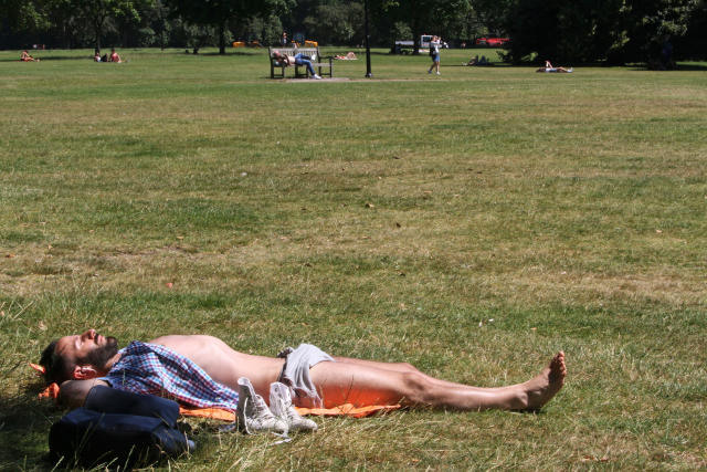 A man sunbathes in Hyde Park in London on Tuesday July 19, 2016. It was the the hottest day of 2016 in Britain, according to the Met Office. (AP Photo/Adela Suliman)