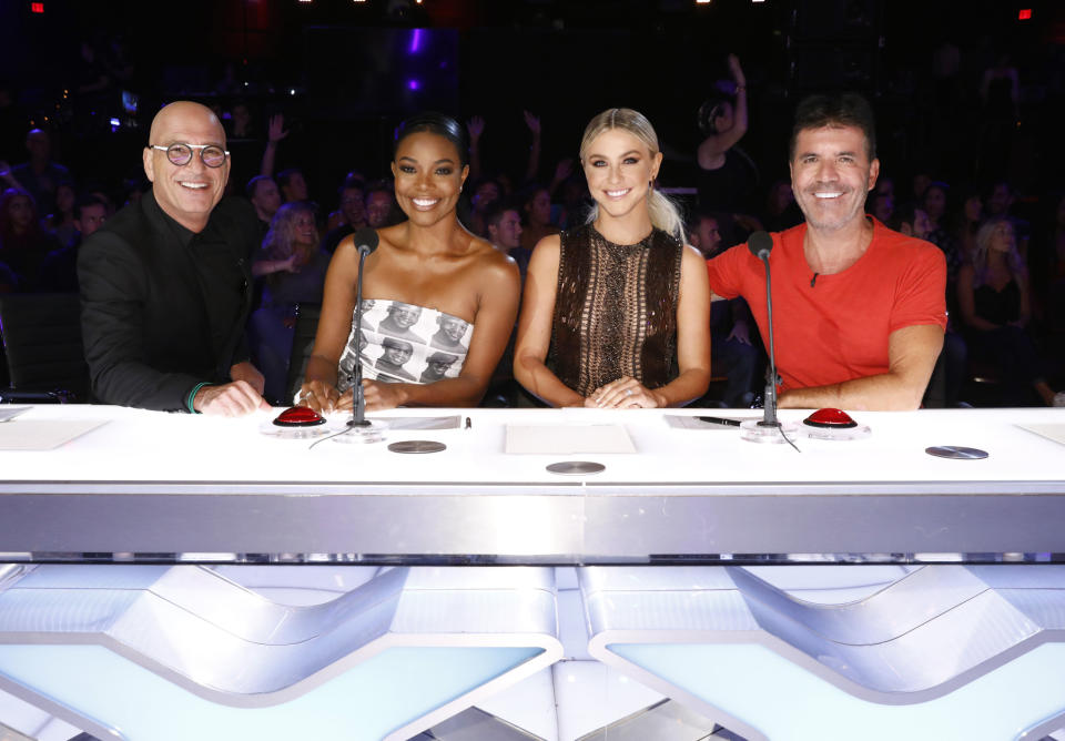 This image released by NBC shows celebrity judges, from left, Howie Mandel, Gabrielle Union, Julianne Hough, Simon Cowell on the set of "America's Got Talent," in Los Angeles. Union is thanking supporters for defending her amid reports she was fired from “America’s Got Talent” after complaining about racism and other on-set issues. Without directly addressing her status with NBC’s talent show, the actress tweeted that the backing helped overcome feeling of being lost and alone. (Trae Patton/NBC via AP)