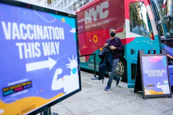 A man walks off a vaccination bus at a NYC mobile vaccine clinic in Midtown Manhattan
