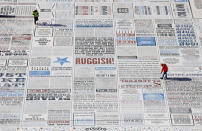 A construction worker sweeps up as the final touches are completed on 'Comedy Carpet' by British artist Gordon Young, the latest art installation on Blackpool's promenade. 'Comedy Carpet' is a giant map immortalising the UK's favourite comedians and comic writers from the hey Day of music hall to 21st century stand up and adorns the new Festival Headland beneath Blackpool Tower. The artwork took five years to compete and features catchphrases, jokes, sketches and is made up from over 160,000 letters individually cut from black and red granite and cobalt blue concrete.