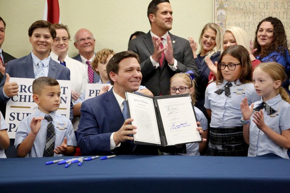 Florida Governor Ron DeSantis signs the ‘Parental Rights in Education Act’ into law on 28 March, 2022. (AP)